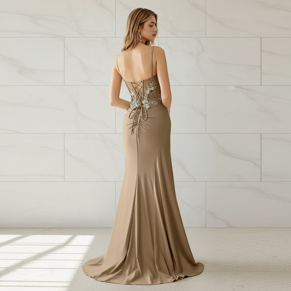 Beige evening gown with intricate back design on a white background
