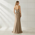 Beige evening gown with floral lace details on a white background