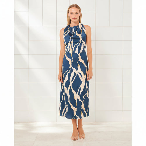 Woman wearing a blue and beige patterned dress on a white background