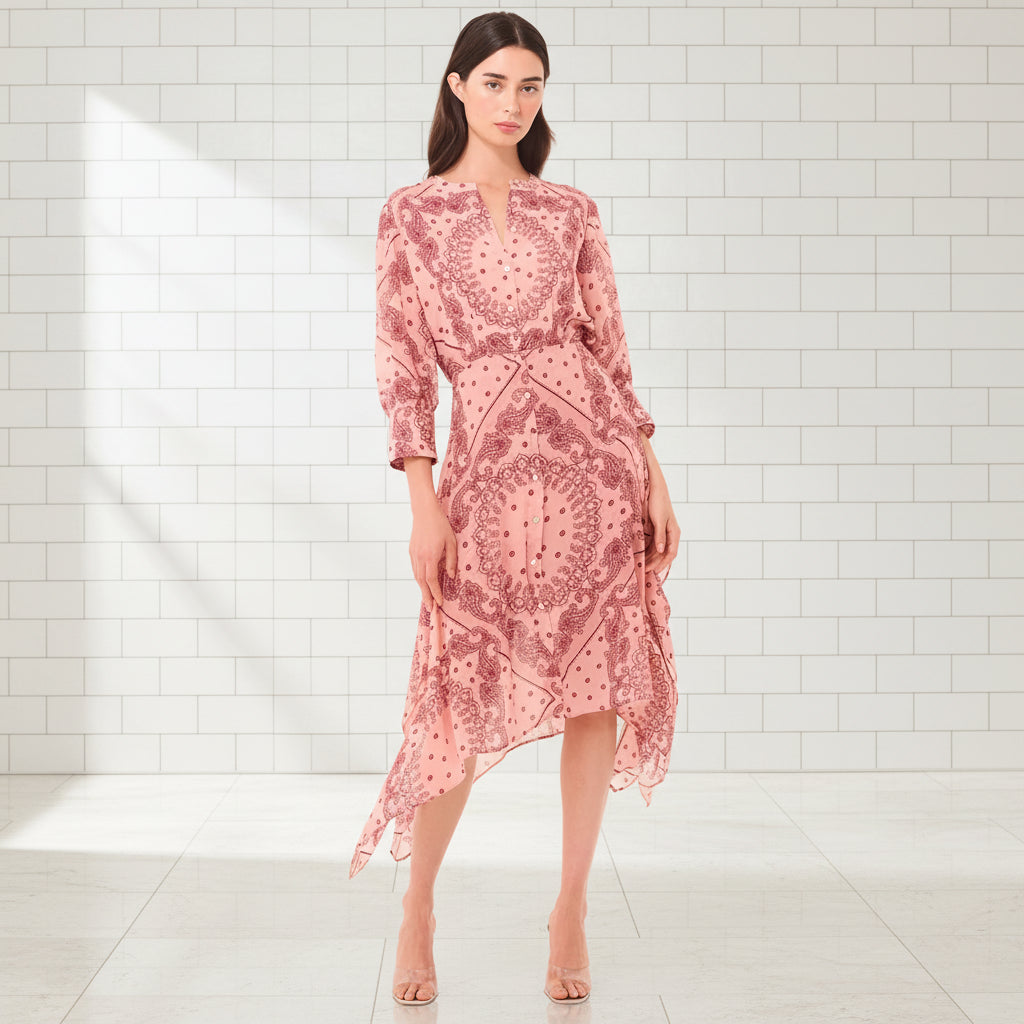 Woman wearing a pink patterned dress on a white background