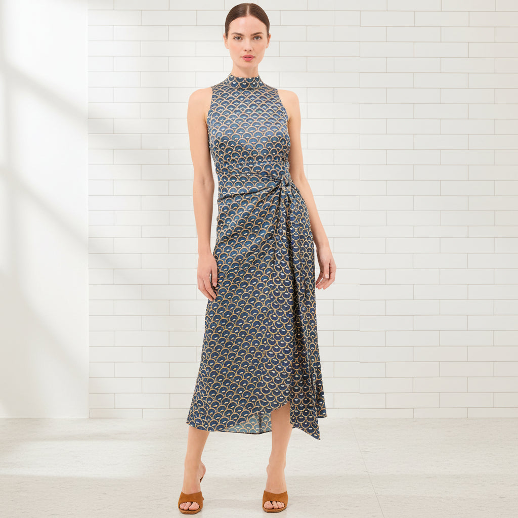 Woman wearing a patterned dress on a white background