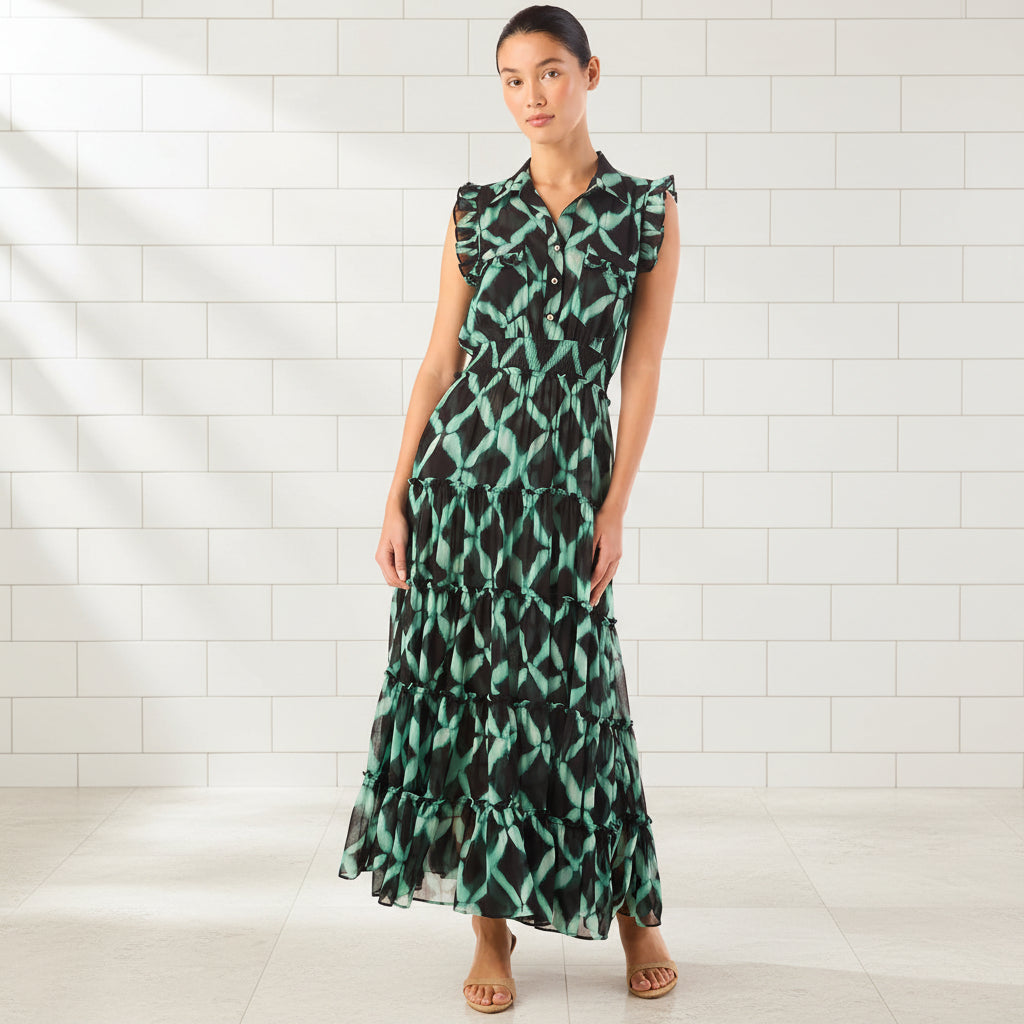 Woman wearing a green and black patterned dress on a white background