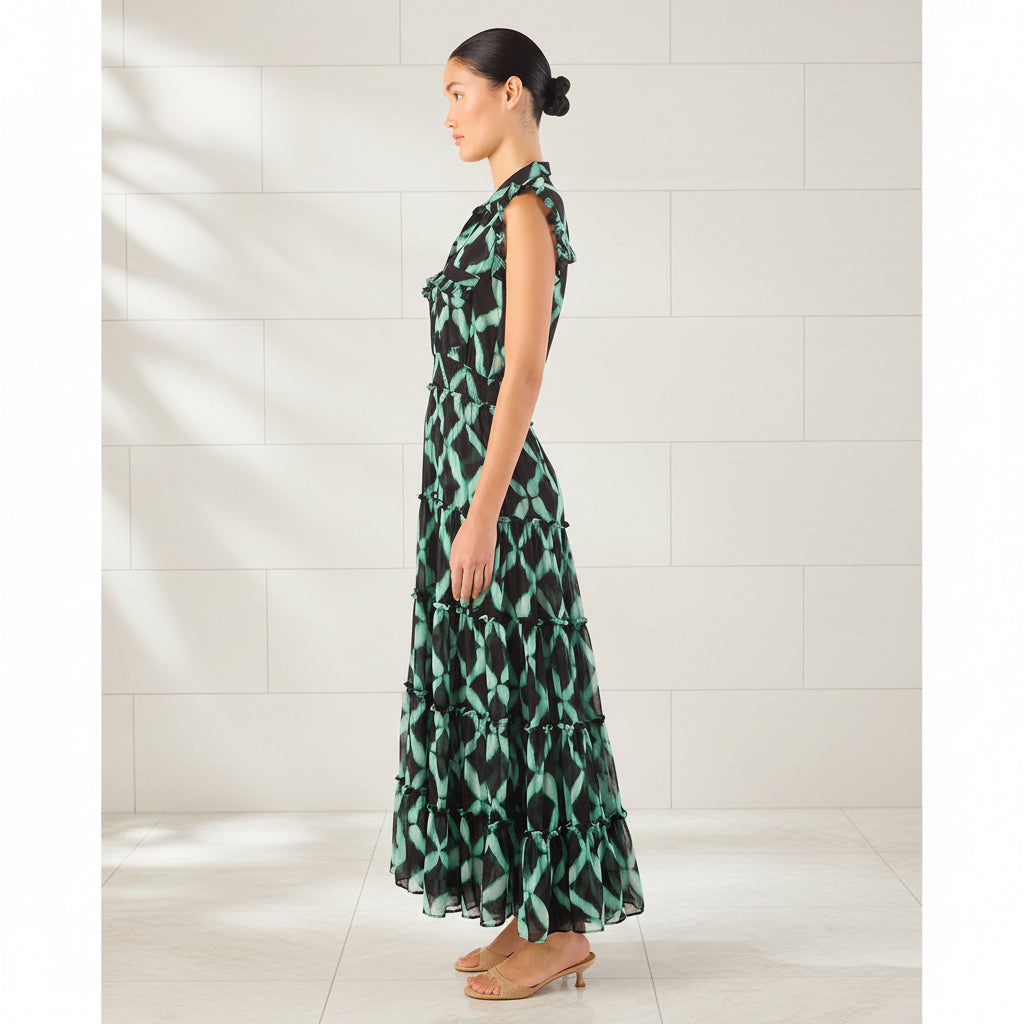 Woman wearing a green and black patterned dress on a white background