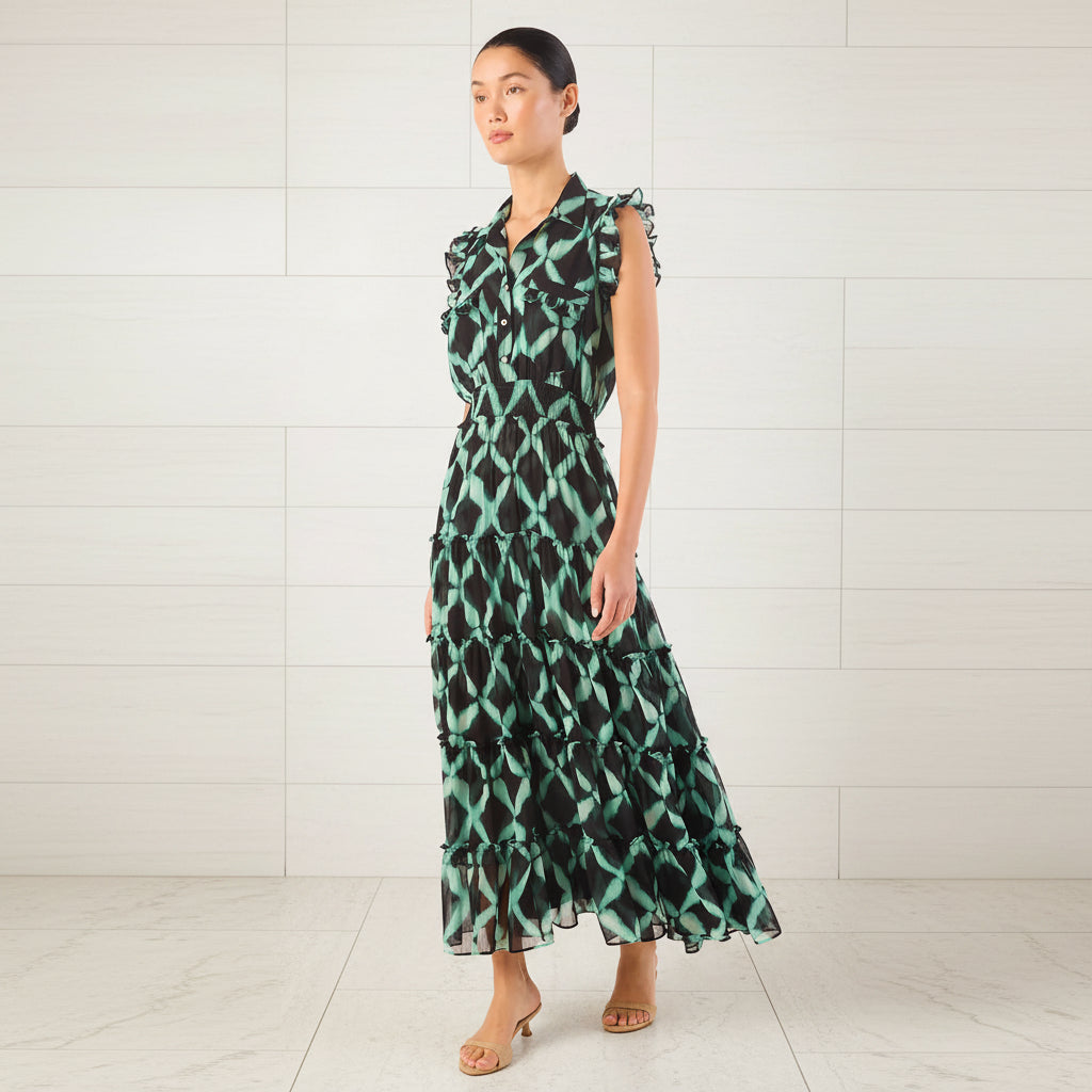 Woman wearing a green and black patterned dress on a white background