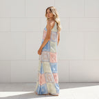 Woman wearing a long, patterned dress on a white background