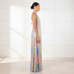 Woman wearing a colorful patterned dress on a white background