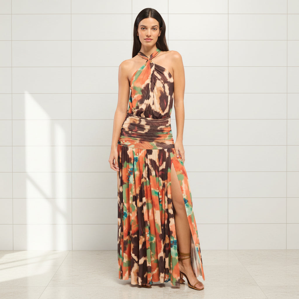 Woman wearing a colorful halter neck dress on a white background