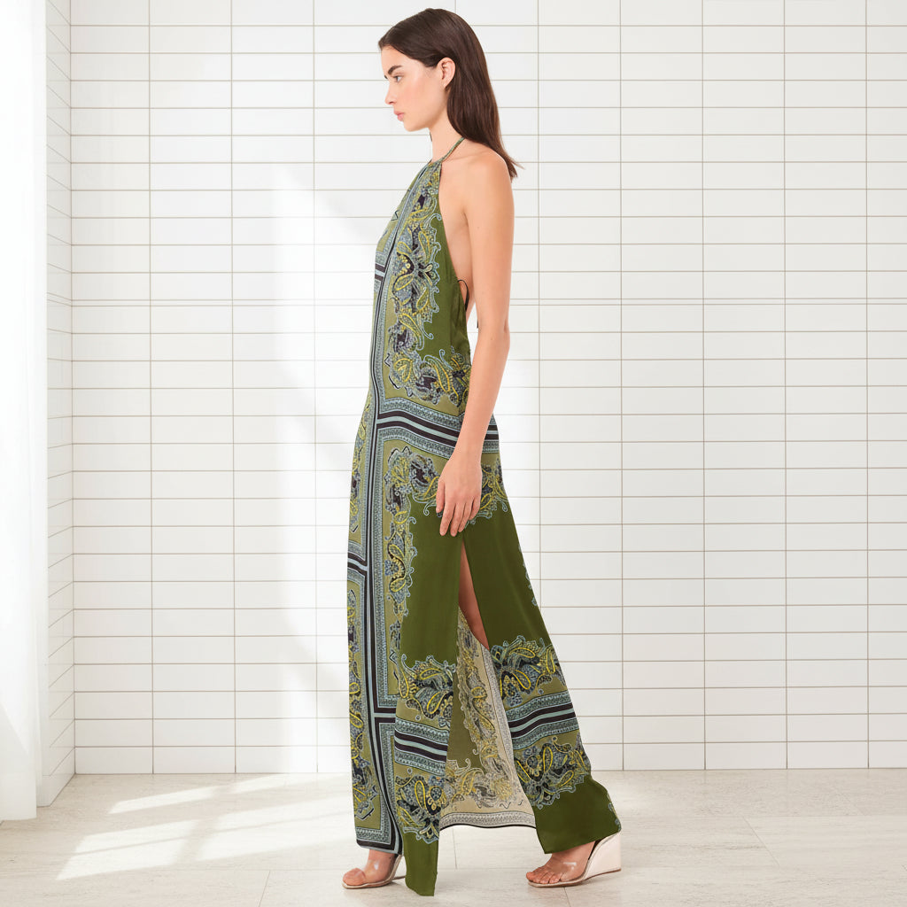 Woman wearing a green patterned dress on a white background