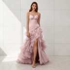 Pink strapless gown with ruffled skirt on a white background